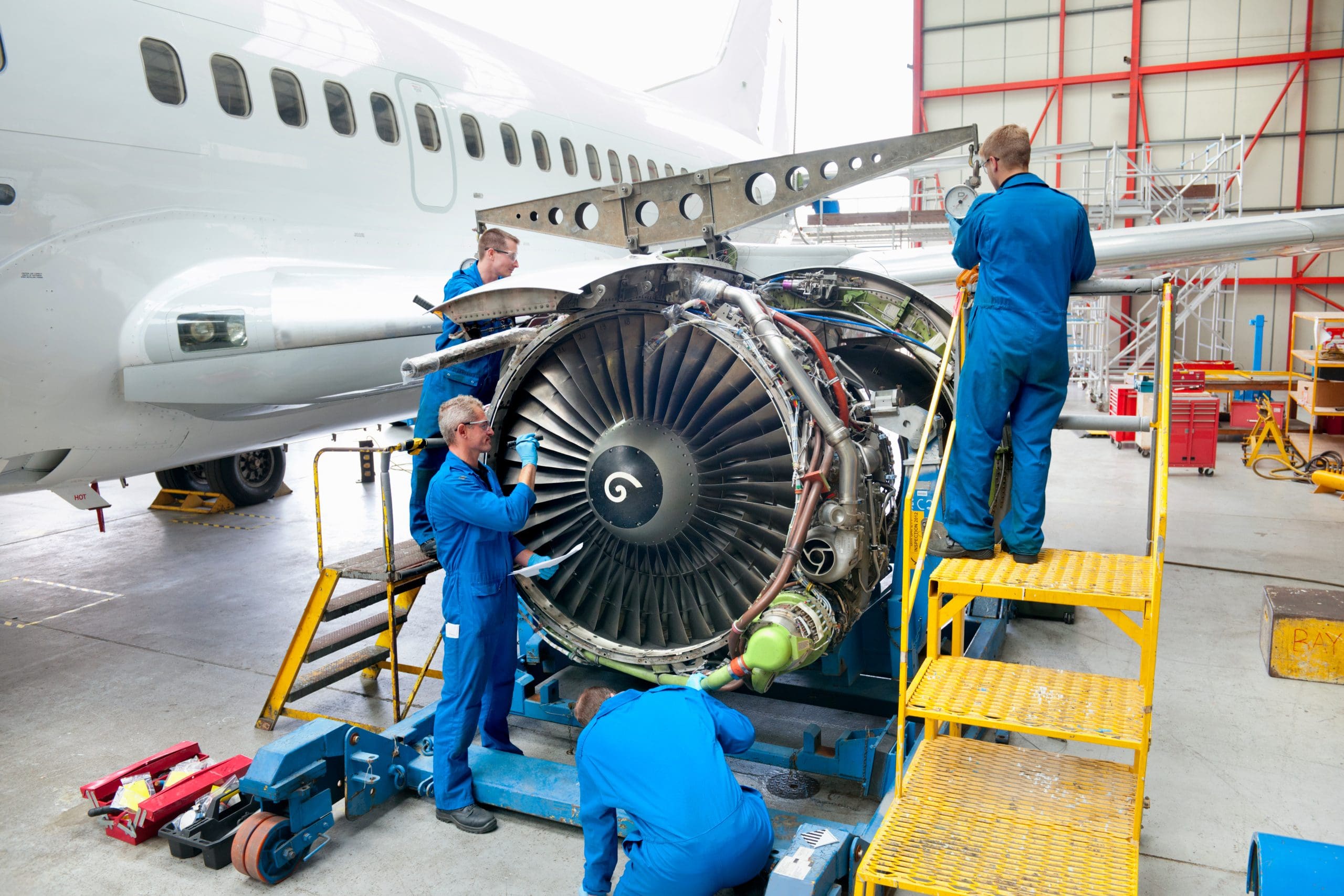 WideShotOfEngineersRepairingTheTurbineEngineOfA WideShotOfEngineersRepairingTheTurbineEngineOfA